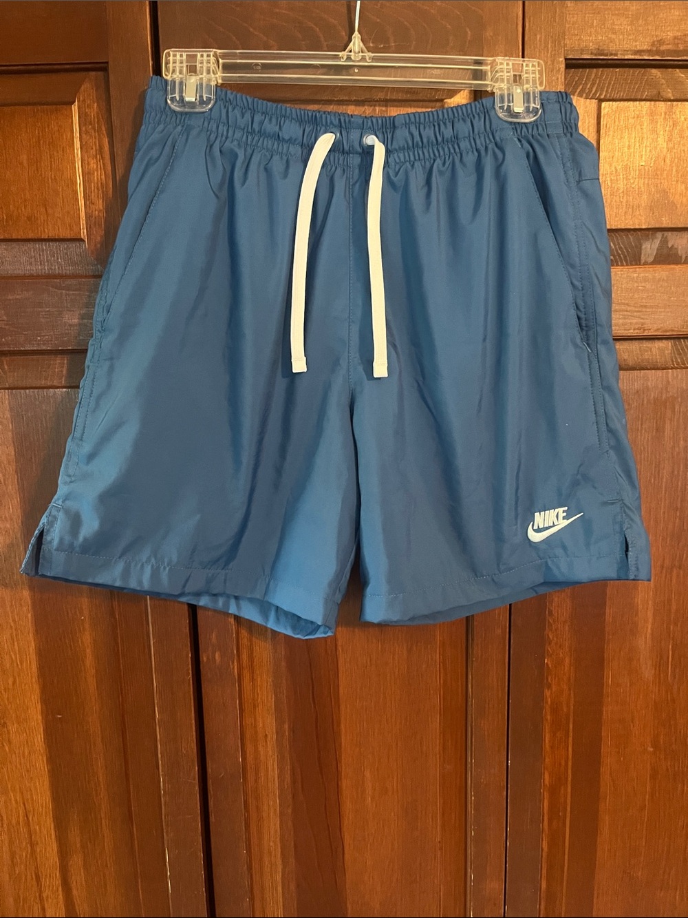 Nike Blue Athletic Shorts with White Drawstring and Swoosh